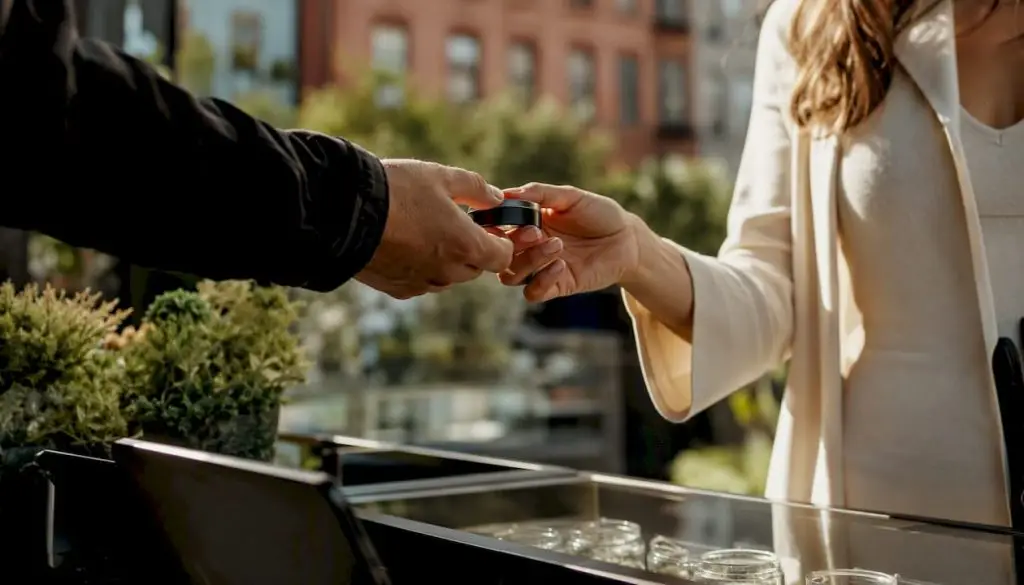 Hand exchanging cannabis container at dispensary