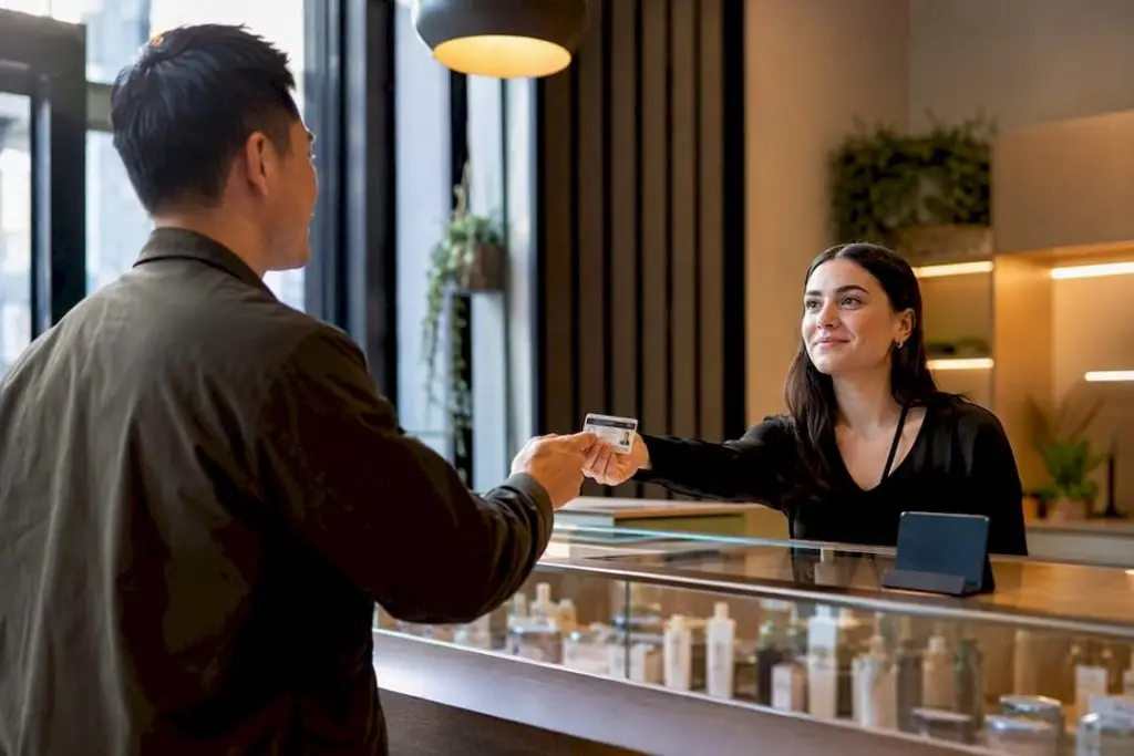 Customer presenting ID at dispensary counter